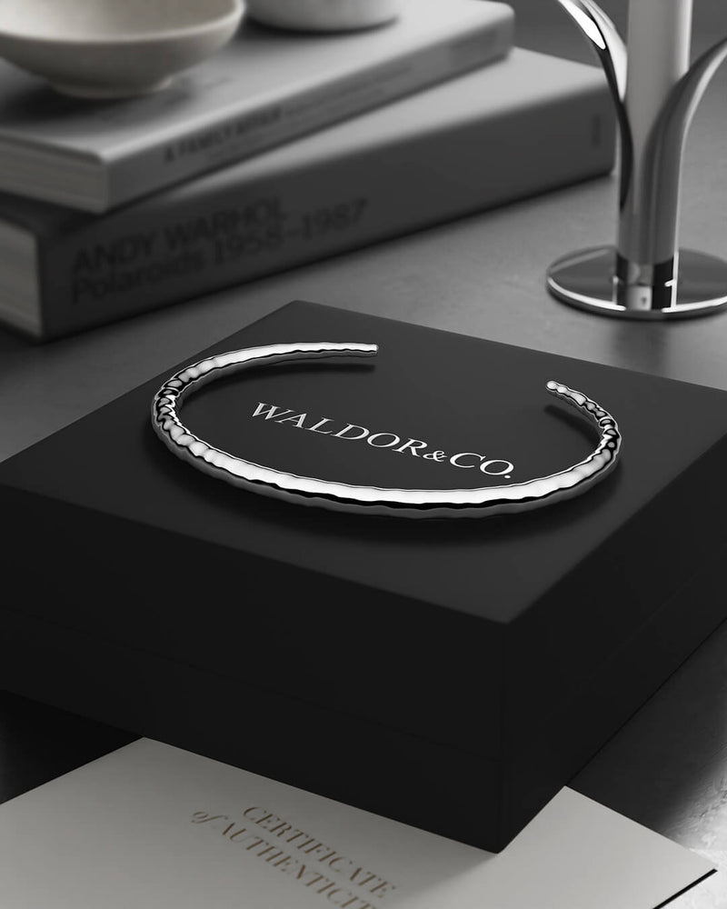 A Round Bangle in 925 Sterling Silver from Waldor & Co. The model is Opal Bangle Sterling Silver