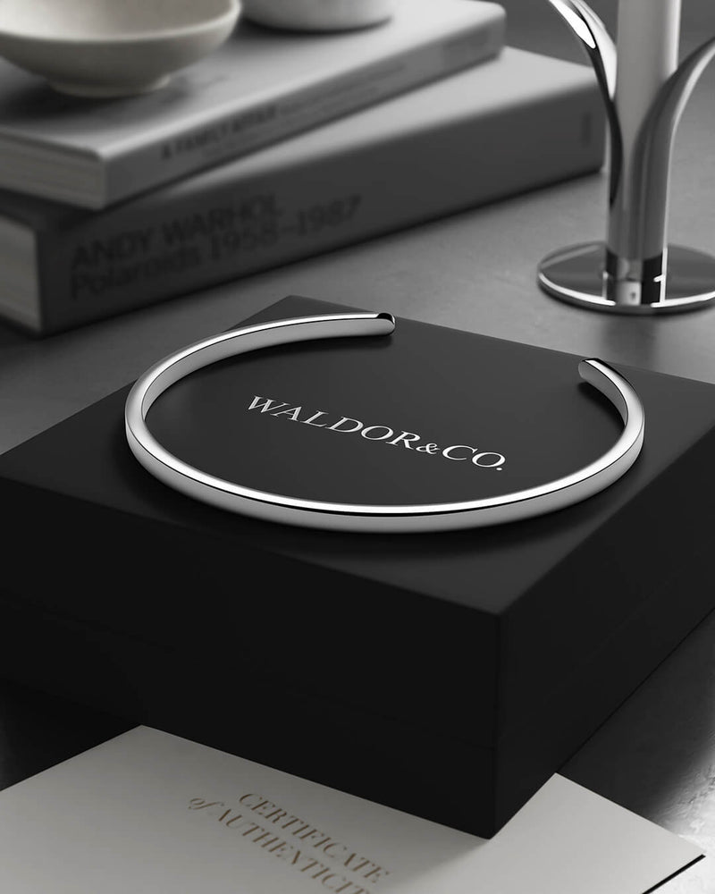 A Round Bangle in 925 Sterling Silver from Waldor & Co. The model is Opal Bangle Sterling Silver