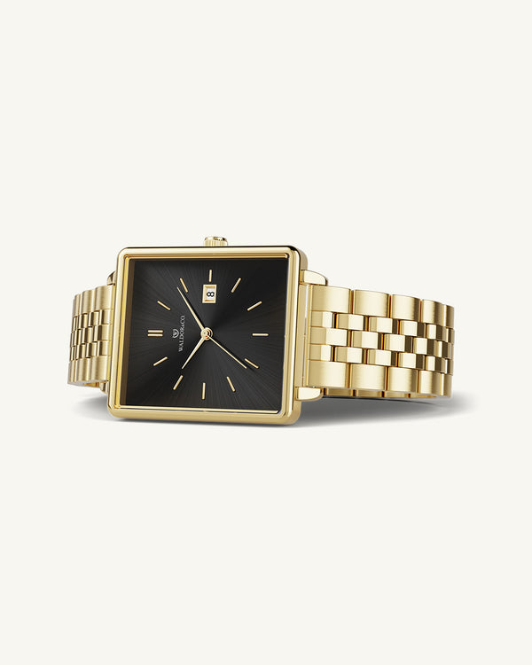 A square womens watch in 14k gold from Waldor & Co. with black sunray dial and a second hand. Seiko movement. The model is Delight 32 Chelsea 28x32mm.