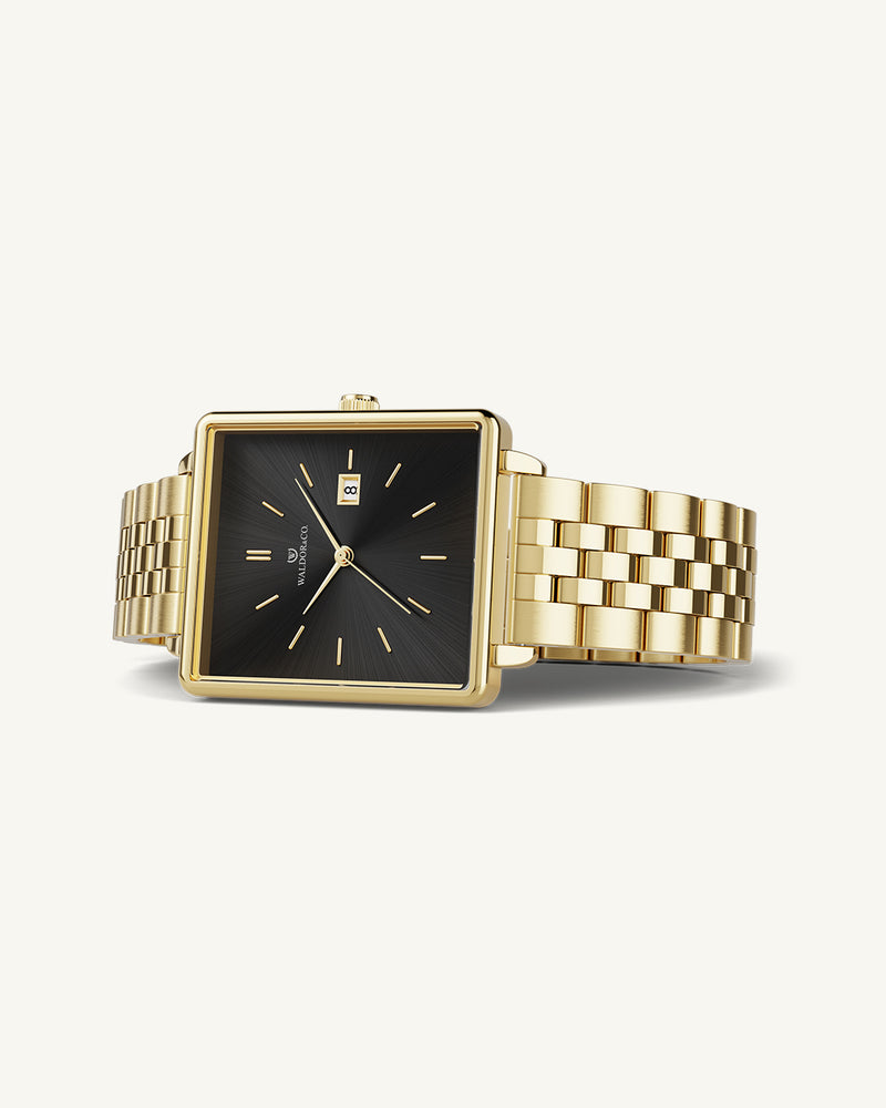 A square womens watch in 14k gold from Waldor & Co. with black sunray dial and a second hand. Seiko movement. The model is Delight 32 Chelsea 28x32mm.