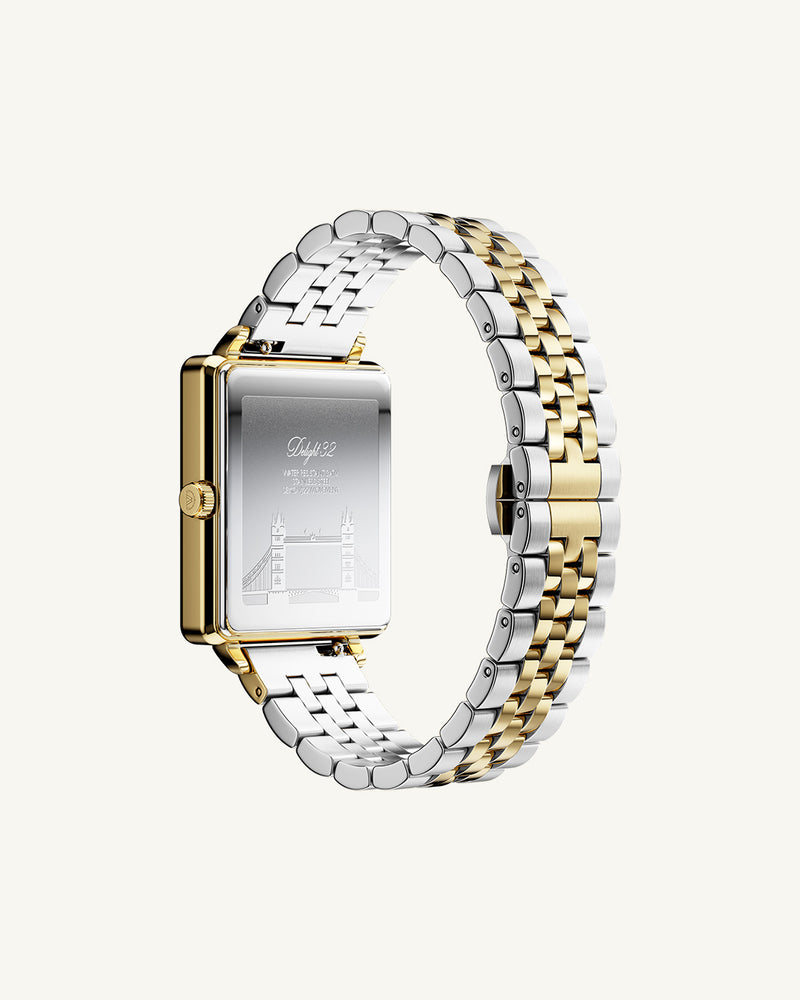 A square womens watch in silver and 14k gold from Waldor & Co. with silver sunray dial and a second hand. Seiko movement. The model is Delight 32 Chelsea 28x32mm.