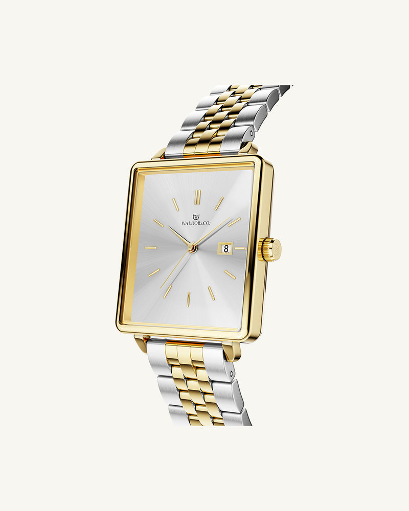 A square womens watch in silver and 14k gold from Waldor & Co. with silver sunray dial and a second hand. Seiko movement. The model is Delight 32 Chelsea 28x32mm.