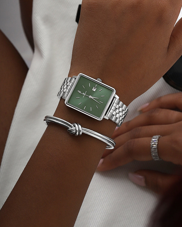 A square womens watch in silver from WALDOR & CO. with green sunray dial and a second hand. The model is Delight 32 Chelsea 28x32mm.