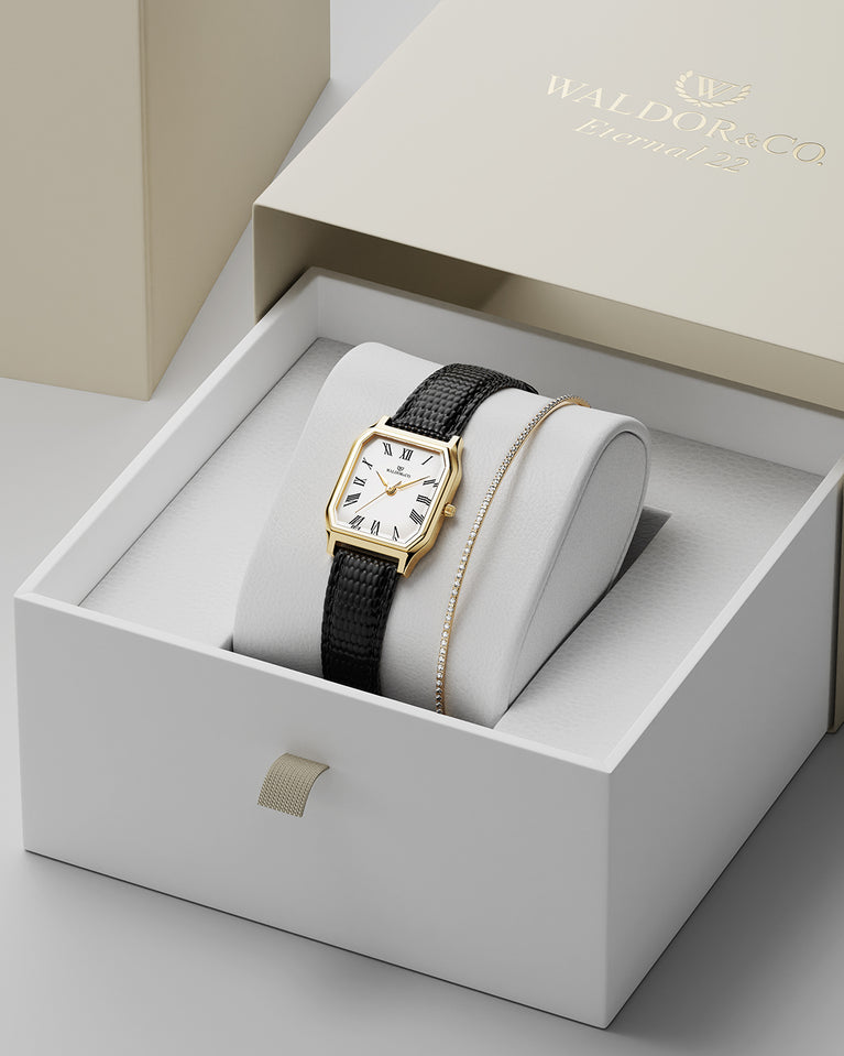 A square womens watch in 22k gold from Waldor & Co. with white Diamond Cut Sapphire Crystal glass dial. Strap in black Genuine leather. Seiko movement. The model is Eternal 22 Varenna.