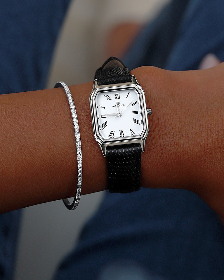 A square womens watch in Rhodium-plated 316L stainless steel with a black genuine leather strap from Waldor & Co. with white Diamond Cut Sapphire Crystal glass dial. Seiko movement. The model is Eternal 22 Varenna.