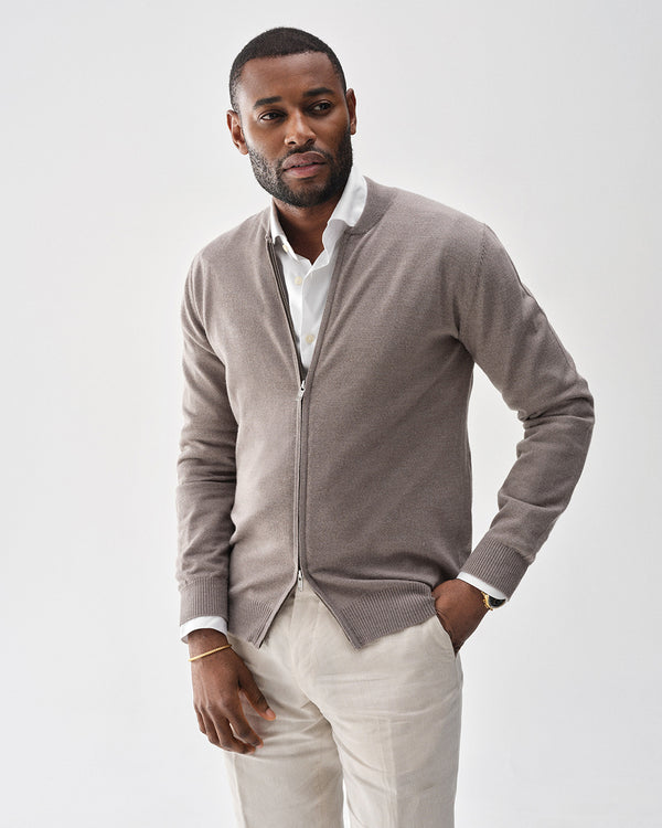 A polished stainless steel bangle in 14k gold plated from Waldor & Co. One size. The model is Noble Bangle Polished