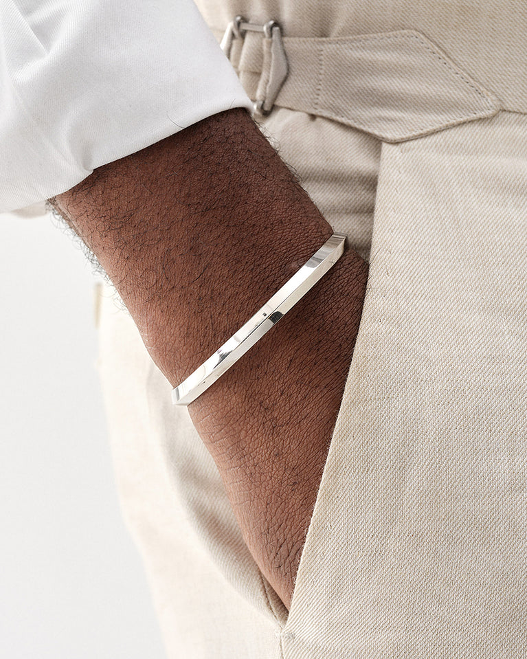 A Bangle in silver plated 316L stainless steel from Waldor & Co. One size. The model is Triangle Bangle Polished.