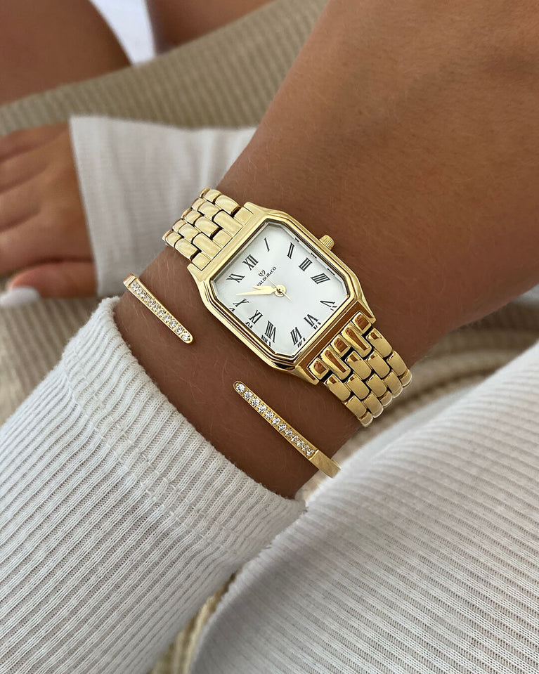 A square womens watch in 22k gold plated 316L stainless steel from Waldor & Co. with white Diamond Cut Sapphire Crystal glass dial. Seiko movement. The model is Eternal 22 Bellagio