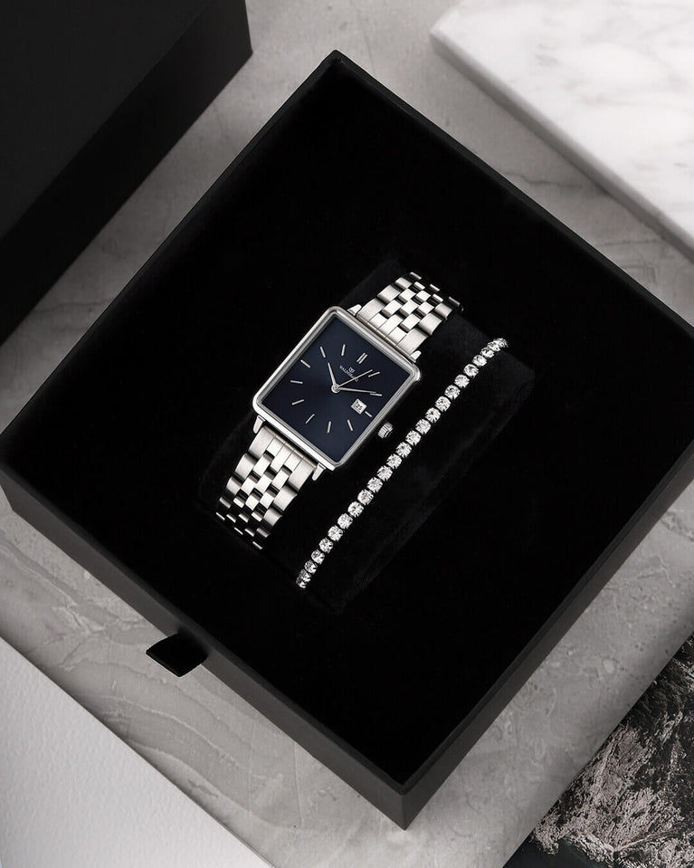 A square womens watch in silver from WALDOR & CO. with blue sunray dial and a second hand. The model is Delight 32 Chelsea 28x32mm.