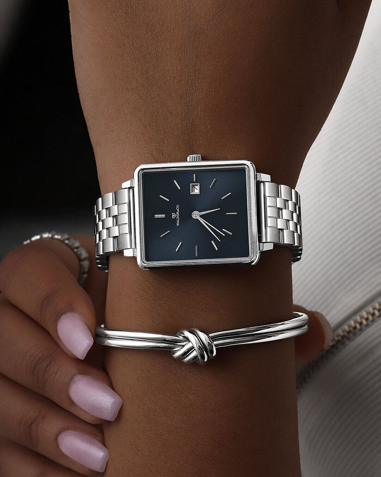 A square womens watch in silver from WALDOR & CO. with blue sunray dial and a second hand. The model is Delight 32 Chelsea 28x32mm.